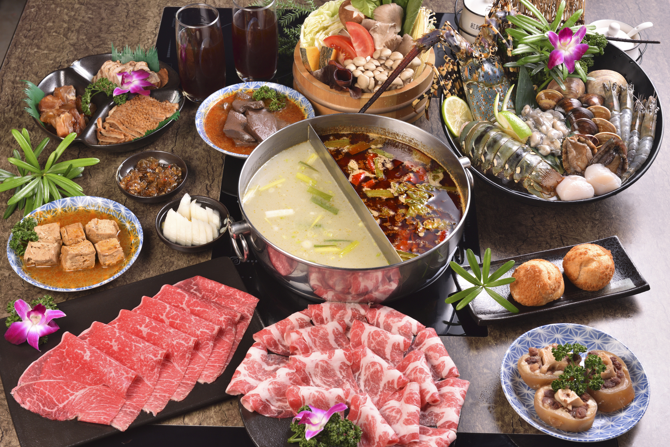 Various food served at the table with Chinese hotpot